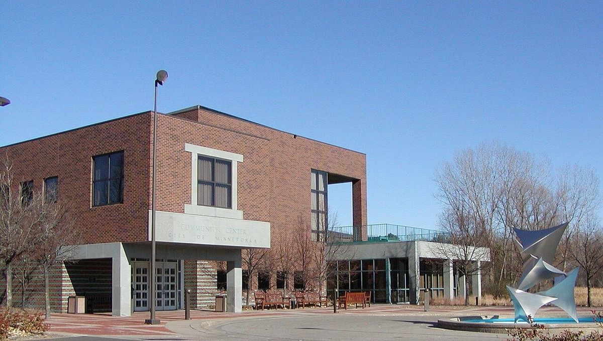 Minnetonka Community Center, a two-story brick building with a steel sculpture and fountain out front