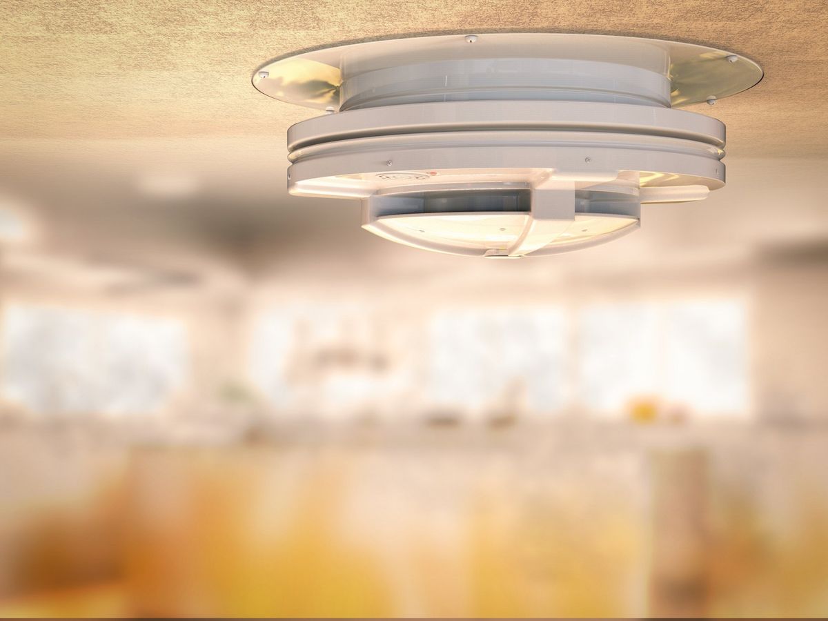 Hardwired smoke alarm mounted on a kitchen ceiling